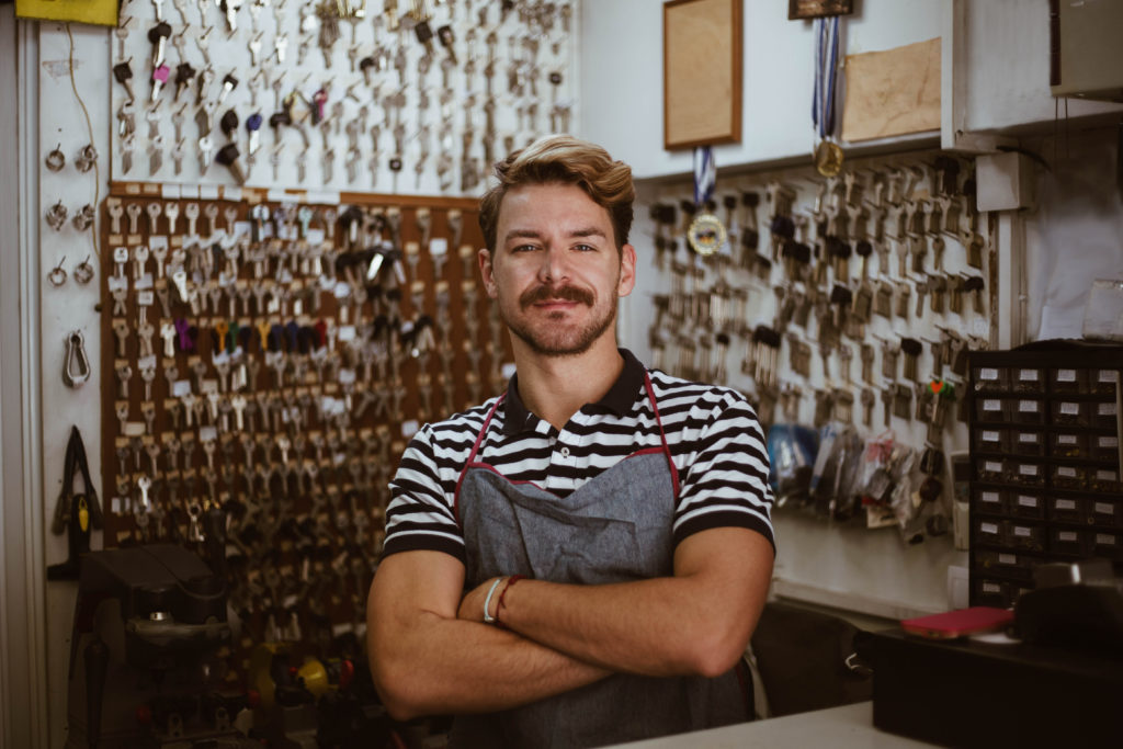 A locksmith poses in his shop