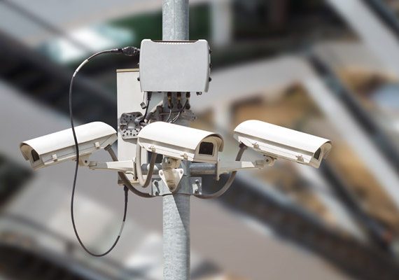 security cameras with blurry modern building image background