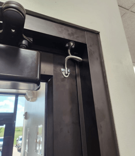 Commercial locksmith in Corpus Christi TX installing and adjusting door closer