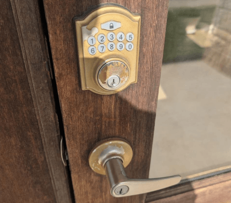 Residential locksmith in Temple TX installing keypad smart lock