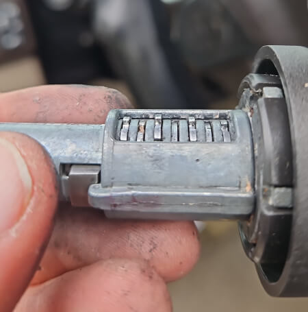 Worn ignition lock cylinder with internal wafers removed during ignition repair in Dallas, TX