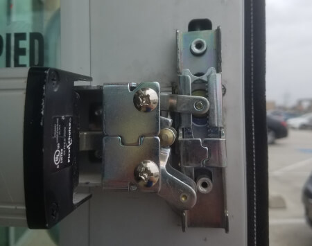 Commercial locksmith in Cedar Park, TX installing panic exit hardware