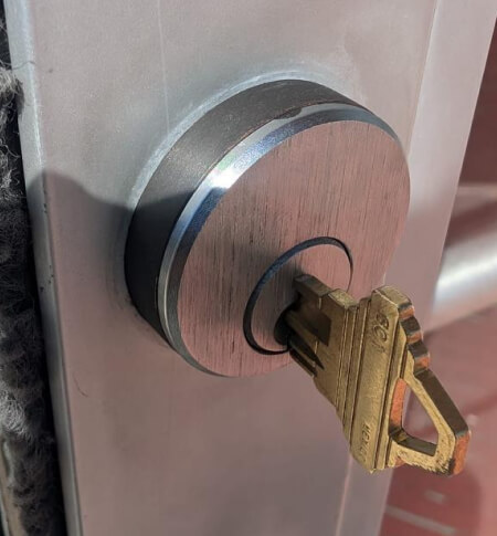 High security mortise cylinder with restricted key installed on a commercial door
