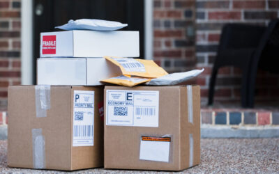 Delivery packages left on a doorstep in front of a home